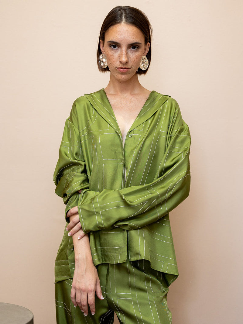 Woman wearing textured silver disc earrings and green top