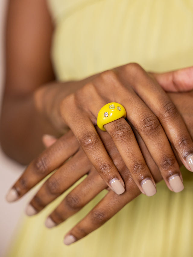 Woman wearing studded yellow ring