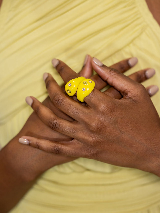 Woman wearing two studded yellow rings