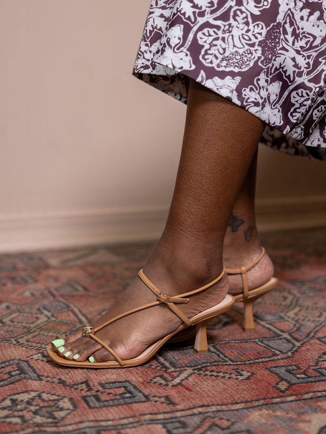Woman wearing tan sandal heel